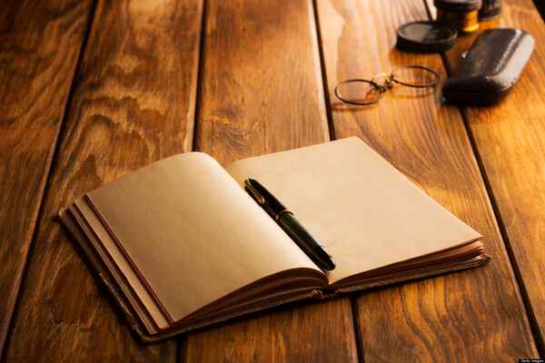 Carnet ouvert et stylo sur une table, ambiance calme